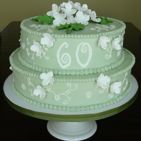 60Th Anniversary Swiss meringue buttercream frosted cake with gumpaste hydrangeas sprayed with edible luster dust.
