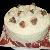 White Chocolate Cake With Strawberrys 10" Round White Cake. Filled with White Chocolate Ganache, Covered with White Chocolate BC, and finished with White Chocolate dipped...