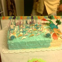 50Th Birthday!! 50 chocolate dolphins holding a candle for each year.This was a TRES LECHES cake with Bavarian cream frosting.