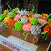 Planter Box Cupcake Bouquet There are 40 total cupcakes in this arrangement. Both reg. and mini's.