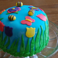 My Fist Cake This is my first cake ever. Its a mother's day cake. I even made my own fondant:) I would have put more detail in it but I have to...