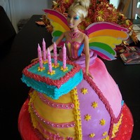 Barbie Cake This cake included the gift for the birthday girl - a rainbow fairy Barbie. I matched the Barbie's dress colors for the ball gown and...