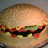 Hamburger buttercream, patty is chocolate cake, lettuce and tomatoes are candy clay