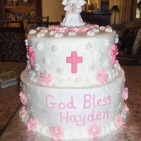 First Communion White buttercream. The crosses are made out of white chocolate tinted pink using molds. The flowers are buttercream made a few days in...