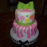 12Th Birthday Cake Two tier cake with fondant decorations and covered in fondant. This is the first time I made a fondant bow.