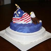 Flag And Eagle 2-layers chocolate cake are stacked and carved in different sizes. The flag is a carved triangle shape of madeira cake. Decorations are...