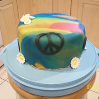 Tie-Dyed Cake Tie-dyed fondant with candy daises & fondant peace signs.