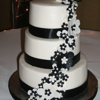 "megan" 8/20/11 Bride just requested a black & white wedding cake. Ribbon at base of each tier. Hand made flowers. Buttercream.