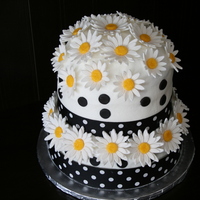 Everything's Coming Up Daisies! My first tiered cake - commissioned for a very special lady's 80th Birthday party with 40 attendees. I can't even tell you how...