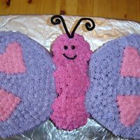 Butterfly Cake This was made with 9" heart pans, 2 layers for the wings and 6 cupcakes stacked 2 high for the body. BC icing. Had fun doing this, no...