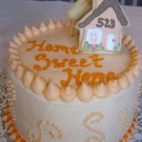 Moving Into A New Home Cake. BC icing with NFSC houses on top.The colour of the house is peach ..... so peach icing and cookies!