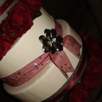 Rich Red And Black Wedding Cake (Dummy Cake For A Catering Service)) mmf covered wedding cake featuring sheer red and black ribbons, silver flower broaches, and silk roses