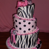 Topsy Turvy Baby Shower buttercream with fondant accents, sps sysytem used, mm fondant booties, pacifier, flowers and bows.