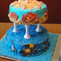 Sand & Sea Two tier cake with sailing ships and crabs made from color flow and sea shells made from gum paste. The sailing ships and sea shells were...