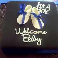 Babyshower Cake All chocolate baby shower cake covered in chocolate fondant. Gumpaste babyshoes. This was my 1st attempt at making them, i use real ribbon...