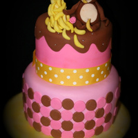 Monkey With Bananas On A Two Tier Cake Pink and brown monkey cake