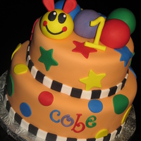 Baby Einstein Caterpillar Cake Created for a first birthday inspired by the Baby Einstein Caterpillar. Decor is fondant.