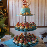 Beach Cupcakes All the coral and shells were either handmade or molded and painted by hand. Buttercream ocean with brown sugar sand. Thanks for looking!
