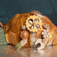 Steampunk Lizard This is a yellow cake with chocolate buttercream. All the gears and fondant pieces are hand cut and painted. All the legs and gears move...