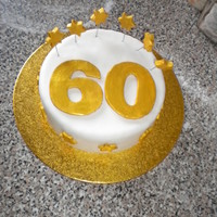 Gold 60Th Birthday Cake Three layered vanilla sponge filled with butter cream and jam. The gold was achieved using edible silk powder watered down with vodka (it...