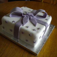 Parcel Cake Lemon cake with a lemon curd centre, covered in white icing and made to look like a parcel.