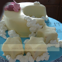 Piglet On Moon Hand molded piglet lounging on top of the moon with stars trailing and clouds hugging stars and moon.