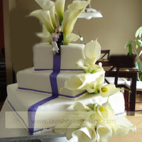 Calla Lily Cake Square cake with calla lillies and "cake runner" to mock a red carpet running down the cake, while sitting Bride and groom lounge...