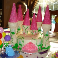 2Nd Castle Cake My 2nd Castle Cake. Cake is fondant and towers are ice cream cones w/sugar sprinkles. Grass/vines were piped on and flowers are fondant.