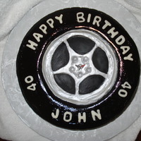Corvette Tire Cake For 40Th Birthday Fondant coverd cake to resemble a tire from a C5 Corvette. Tread pattern, rim pattern and all details made to match actual tire.