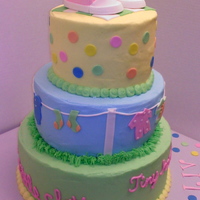 Tiny Hands, Three tier, buttercream iced, baby shower cake. Gum paste pink baby converse shoes, and fondant clothes on clothes line, and fondant dots...