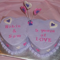 Hearts An anniversary cake made from a 6" heart pan. BC with MMF decorations.