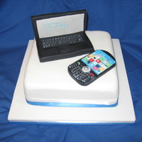 Laptop And Blackberry Cake all bottons were hand cut and hand painted. apps on phone were all cut to size and then hand painted.