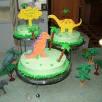 Dinosaur Cakes dinosaur cake with whipped icing and color flow dinosaurs.
