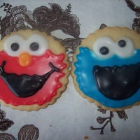 Elmo And Cookie Monster I made these for my son's first birthday. First time decorating cookies. I freehanded them. They are NFSC and I used the glaze icing...