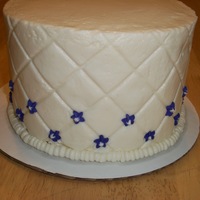 Quilted Cake 6 inch vanilla buttermilk cake filled blueberry jam. Iced in vanilla buttercream.Decorated with royal icing flowers. My first time using an...