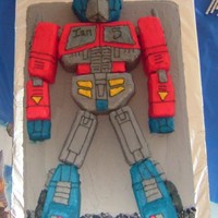 Transformer Cake 9x13 cake pieced together as optimus prime on top of a sheet cake. Frosted with buttercream.