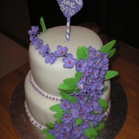 Wedding Shower Cake With Violets Two tier white cake with raspberry filling and vanilla fondant and gumpaste violet sugar flowers