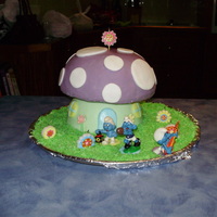 Smurf House Fondant covered cakes with dyed shredded coconut for grass.