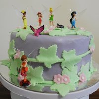 Tinkerbell Cake 4-layer chocolate mud cake with dark chocolate ganache filling and sealing. Purple fondant icing with ivy leaves and blossoms. Finished...
