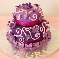 Baby Gracie Lemon cakeRaspberry fillingCovered in fondant with fondant/gumpaste butterfliesDusted with pink lustre dust and edible glitterOriginal...