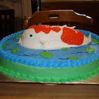 Koi Cake First cake I've done in about 8 yrs. base is chocolate cake with buttercream frosting and color flow lily pads, koi is sculpted out of...