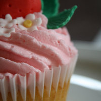 Strawberry Topped Cupcake 'Summer garden' themed party. Sugarpaste strawberry with vanilla cupcake and strawberry frosting.