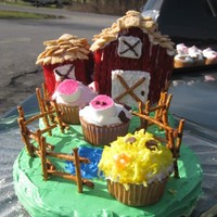 Barn Cake Barn and a silo with a pretzel fence, a lake and animal cupcakes