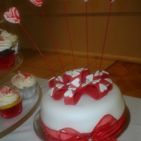 Egagement Cake/cupcakes Engagement Cake for my mom. Top tier with chocolate mud cake and white rolled fondant. Fondant bow and swirl hearts on wires.Cupcakes choc/...