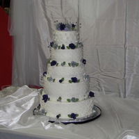5 Tier Wedding Cake. My First! 14,12,10,8 and 6. white,chocolate, strawberry, lemon and lemon! butter cream frosting with purple and silver fondant roses. They loved it!...