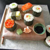 Sushi Cake All edible! vanilla cake with mocha cream filling and mmf covering. Sushi pieces are all cake with mmf and white sprinkles for decoration....