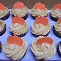 Vanilla Pumpkin Cupcakes Vanilla cupcakes with pumpkin frosting topped with a pumpkin made from scrapbooking.