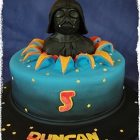 Darth Vader Cake Dark chocolate mudcake with chocolate ganache and fondant. DV is made from RKT covered with moulded chocolate fondant and airbrushed black...