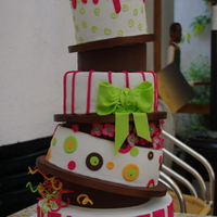 Pink, Brown And Lime Topsy Turvy Topsy turvy with styrofoam wedge separators. Top tier is a dummy, bottom 3 are ganached (had to cover them while this was too soft .. sigh...