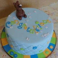 Bear And Butterflies Baby shower cake .. chocolate mudcake with dark chocolate ganache under fondant. Bear, buttons and butterflies made from CMC-hardened...